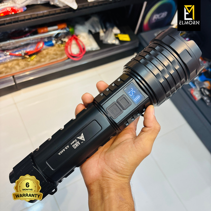 Hand holding a black flashlight with digital display, brand 'ELMORN' visible, warranty badge at the bottom.